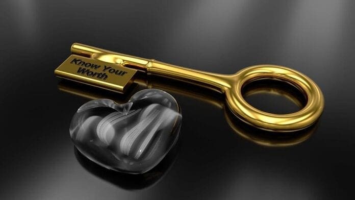 A gold key with an engraving.