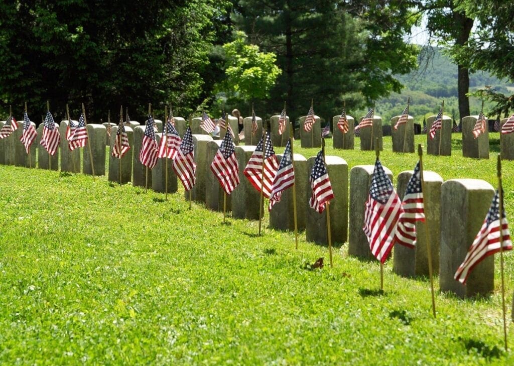 A cemetery with American Flags flying.