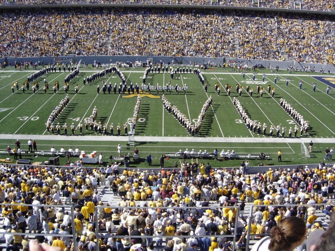 A photo of college band on a football field.