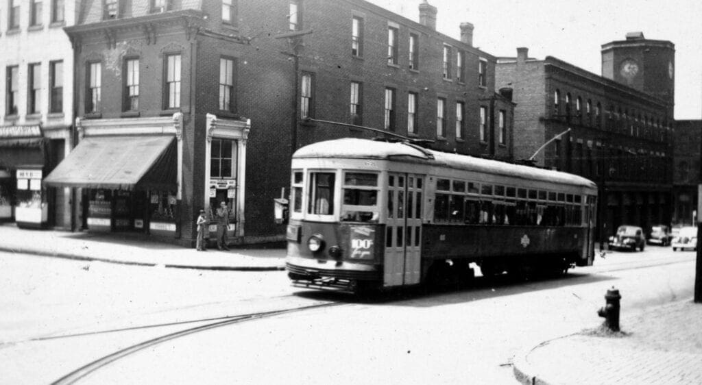 A trolley in the middle of c city street.