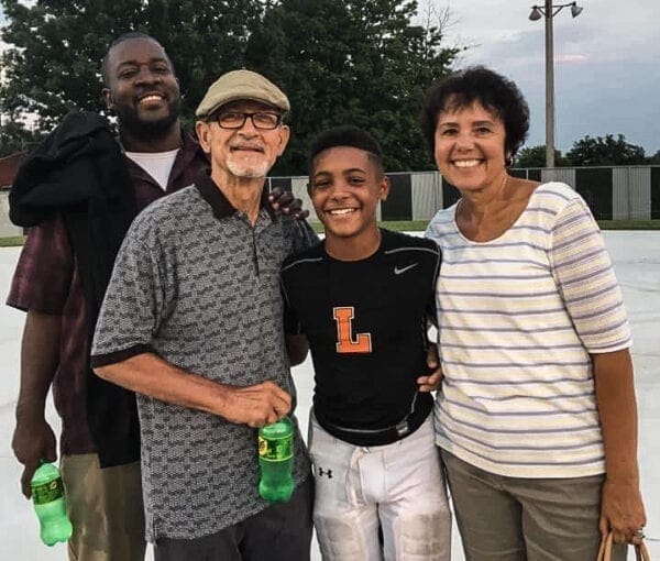 A black man with his won and his girlfriend's parents.