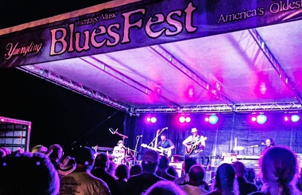 A colorful photo of a band on stage.