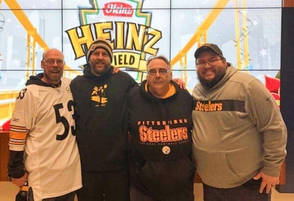 A group of men at a football stadium.