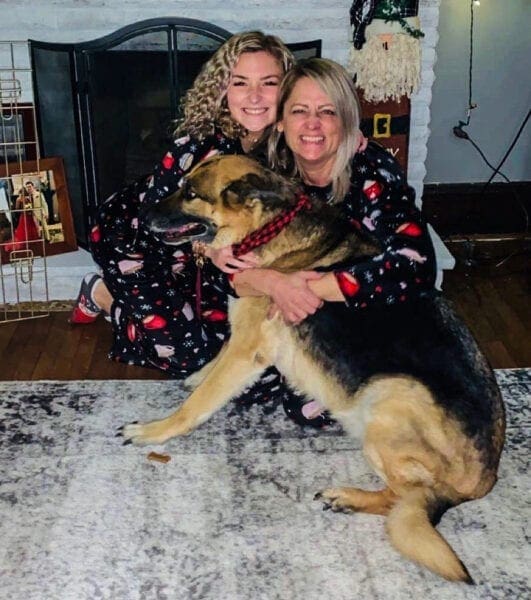 A mother and daughter with their dog.