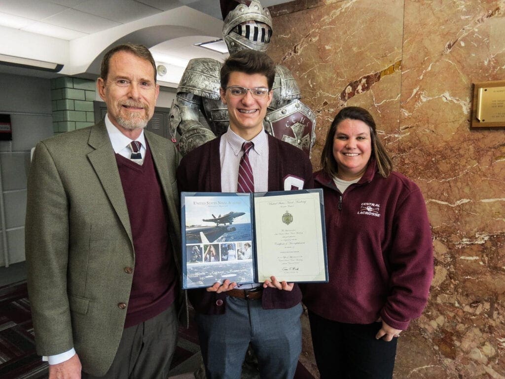 A student in between two administrators.