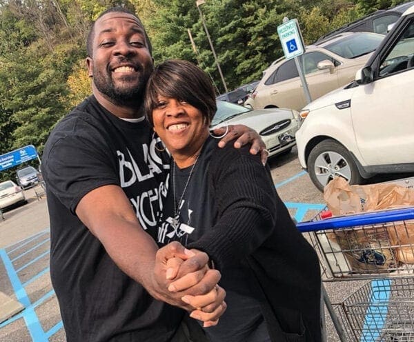 A black man with his mother.