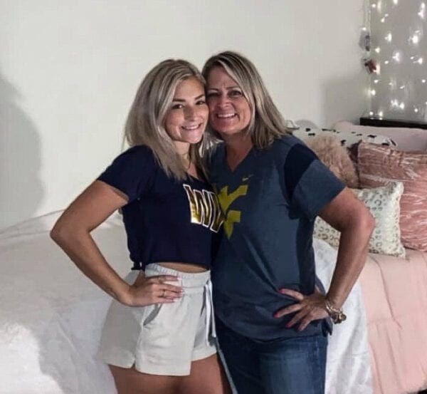 A daughter with her mother in a dorm room.