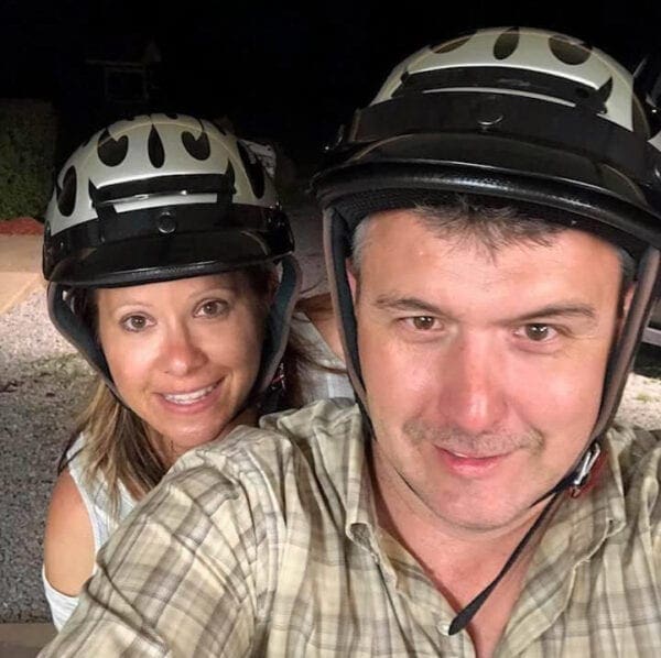 A man and woman on a motorcycle.