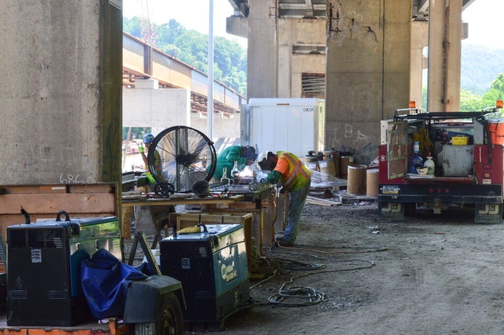 Two construction workers welding.