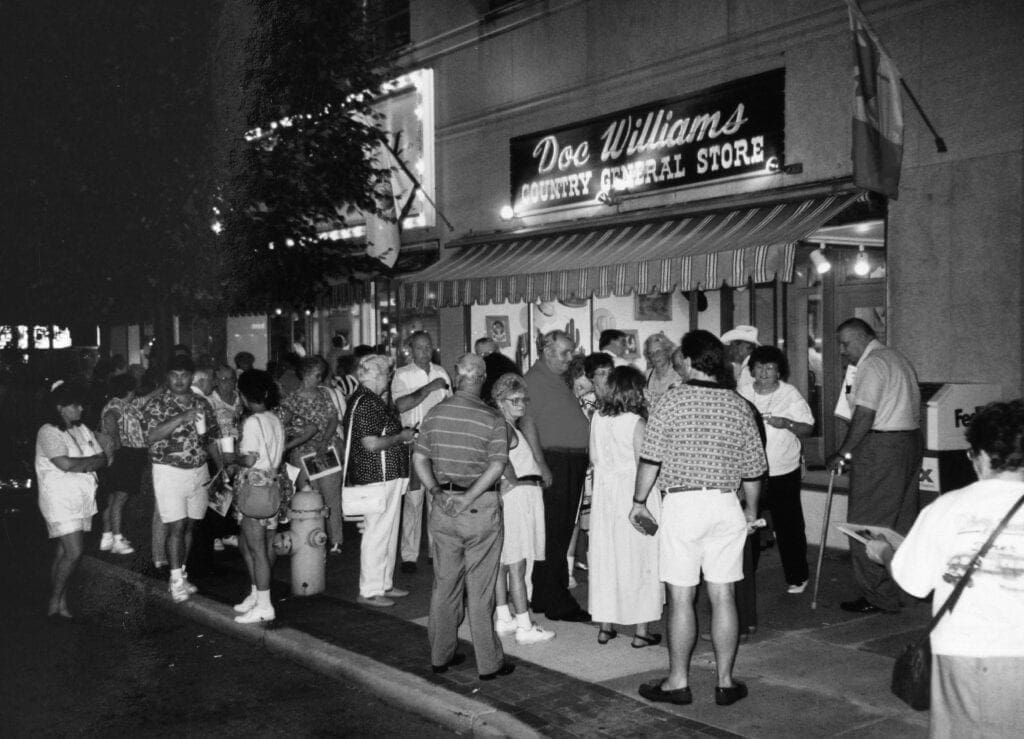 A large crowd outside a store.