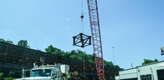 A crane lifting a bridge part.