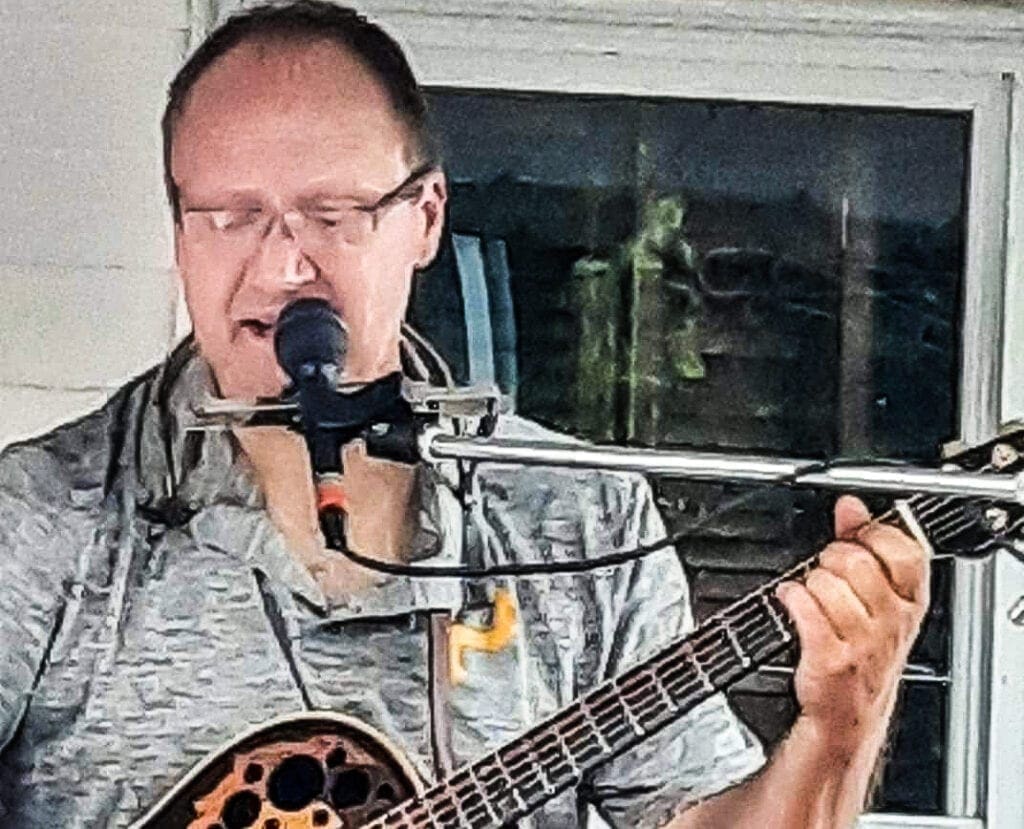 A man playing a guitar.