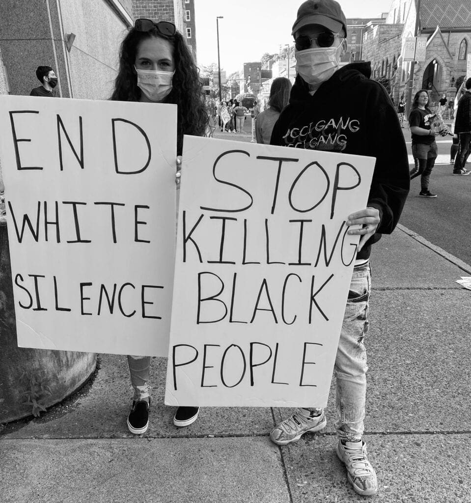 Two signs during a Black Livers Matter protest.