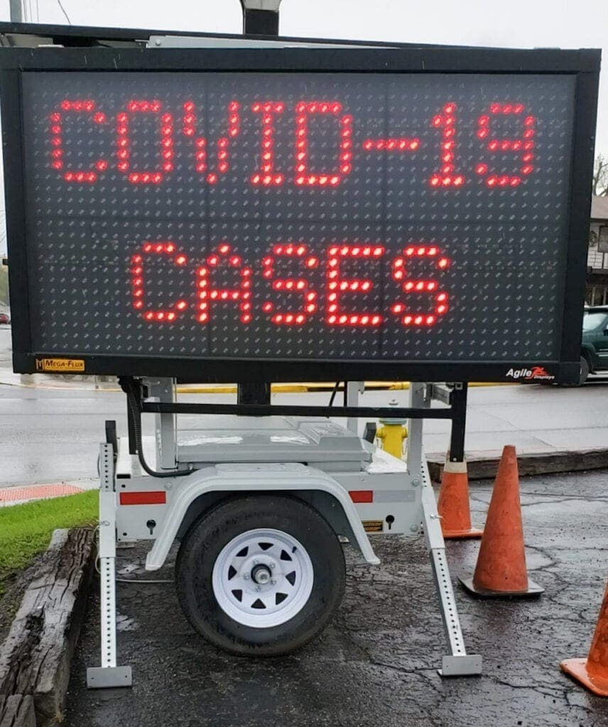 A road sign with Covid information.