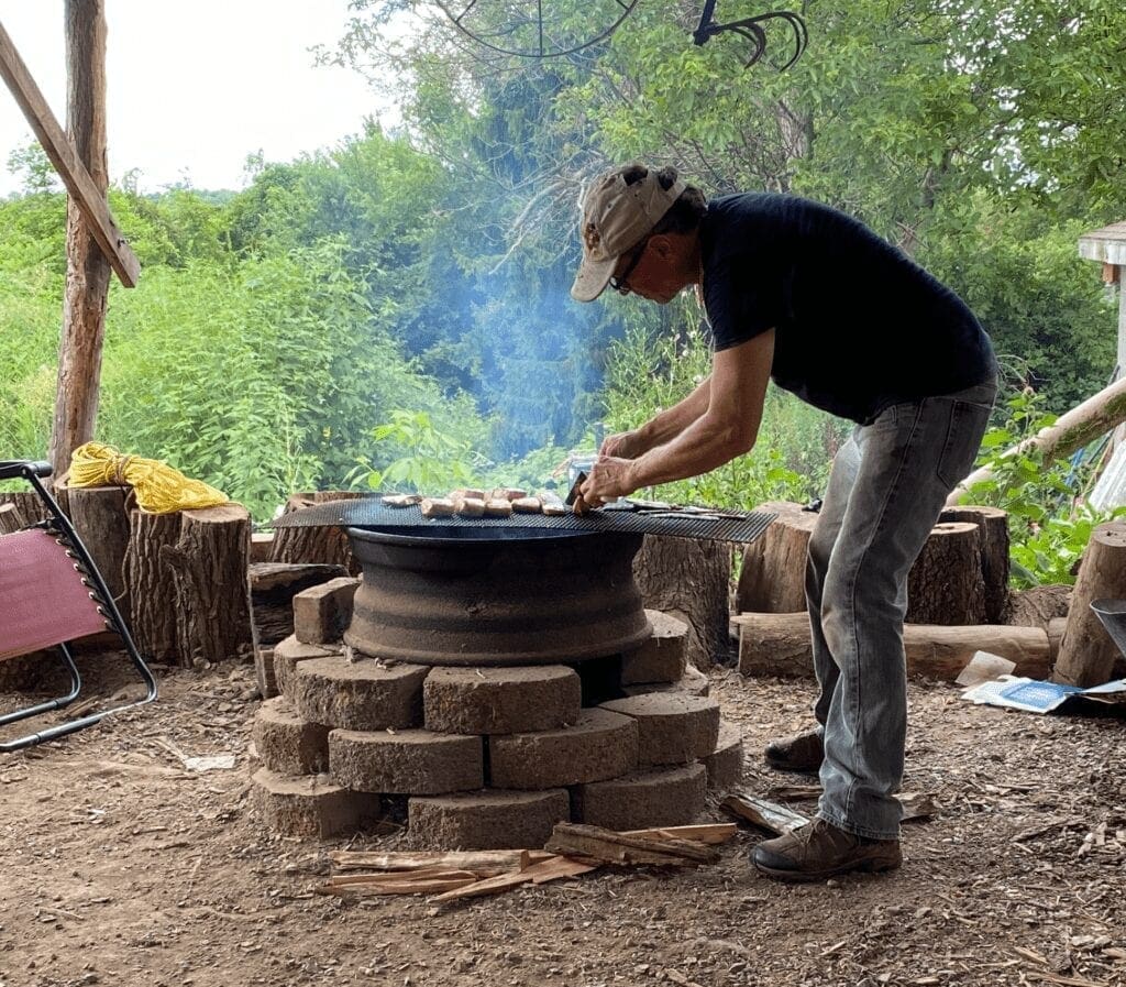 A man cooking over an open fire.