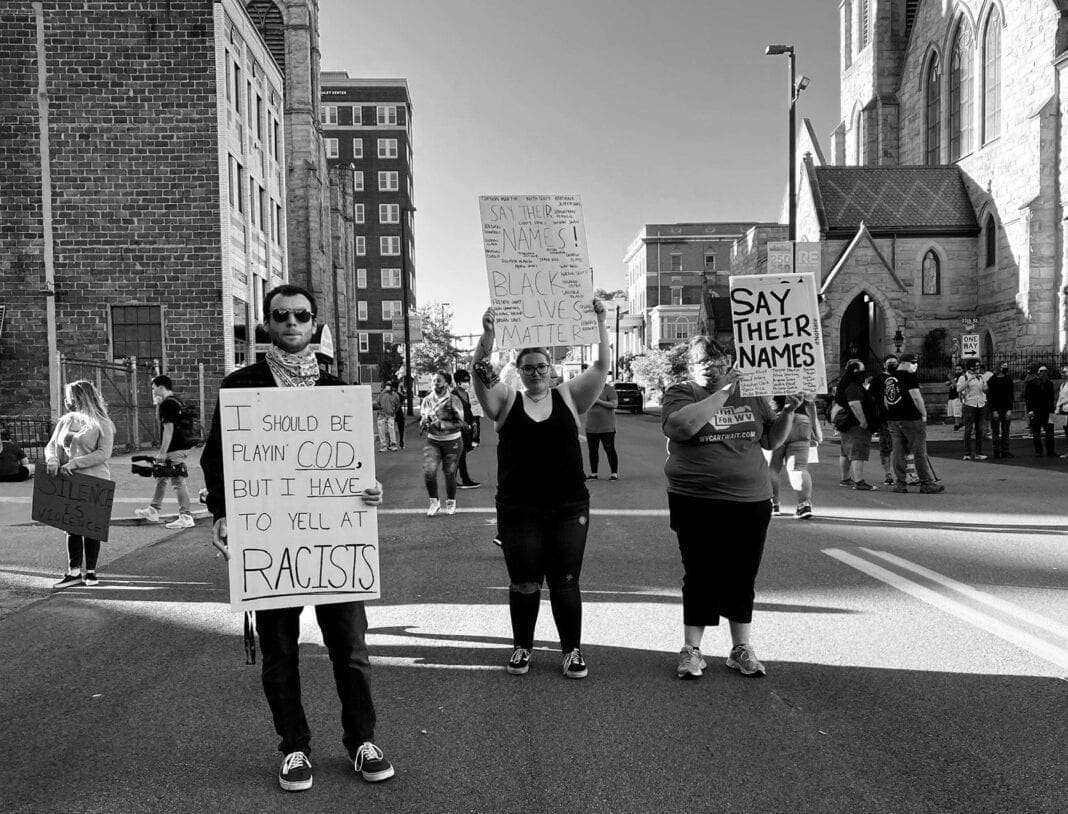 A number of peaceful protesters holding signs.