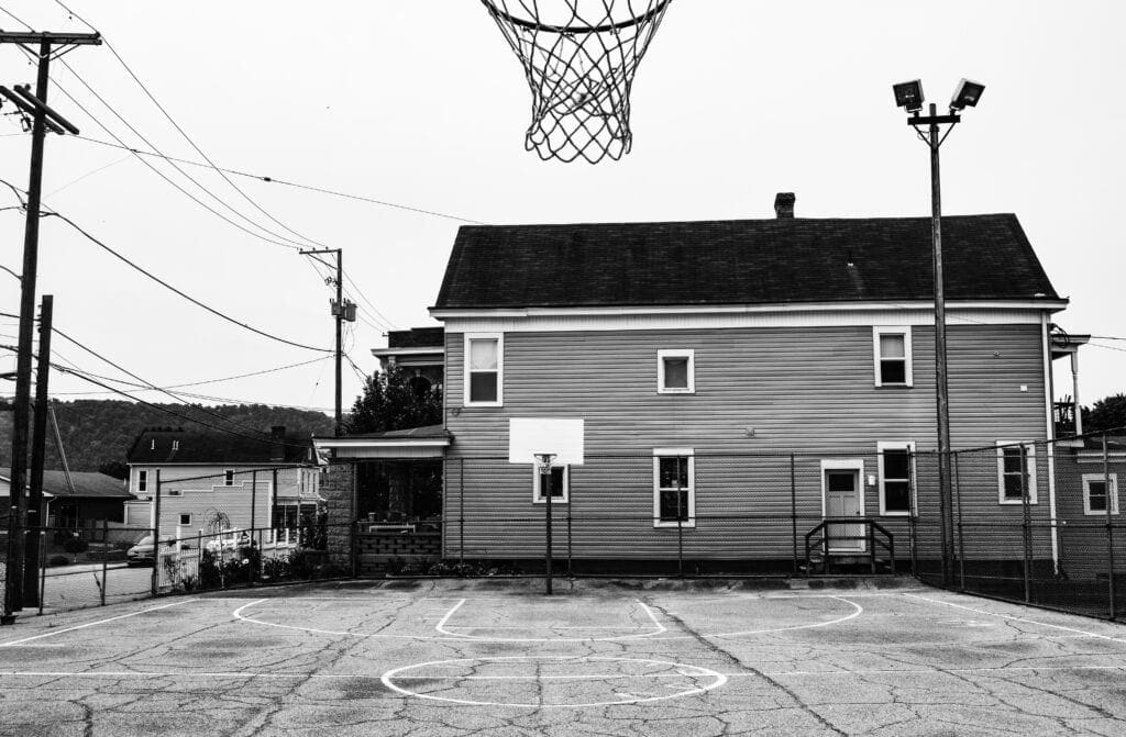 A photo of a playground basketball court.