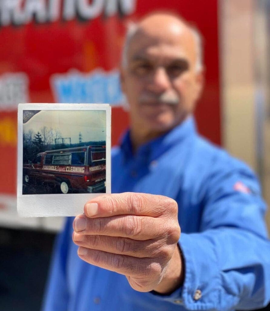 A man holding a photo.