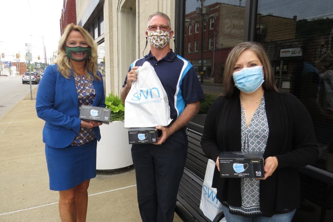 A photo of three people wearing masks.