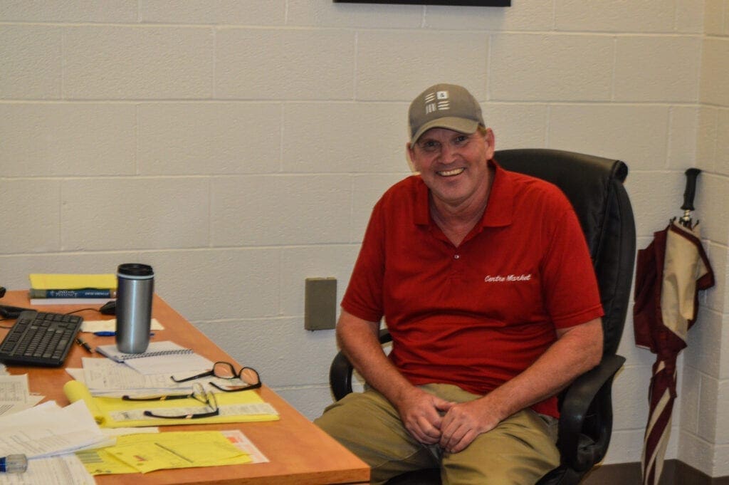 A photo of a man at his desk.