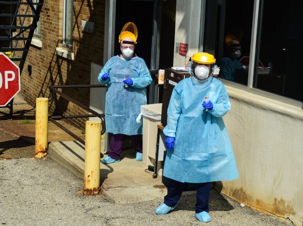 Two nurses in PPE.