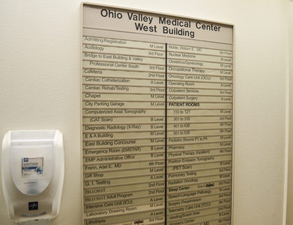 A sign on a wall inside a hospital.