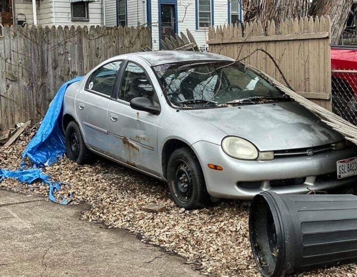 A photo of an abandon sedan.