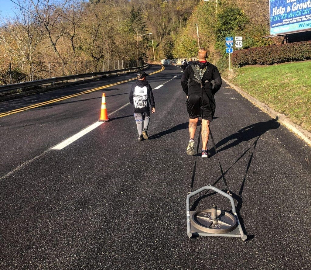 A running pulling a sled.