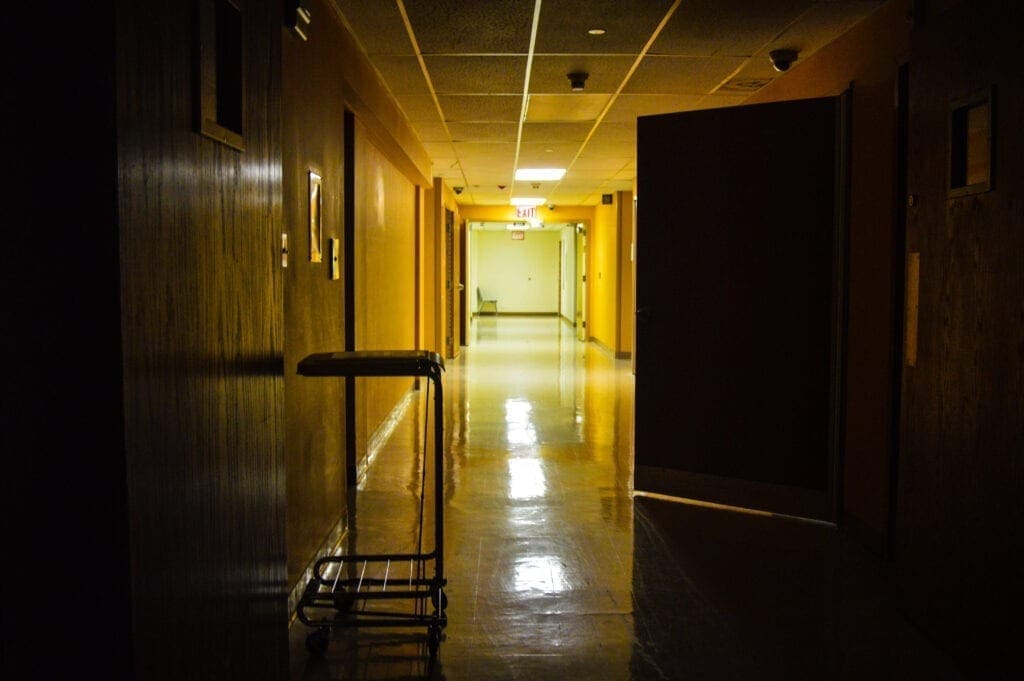 A dark hallway in a former hospital.