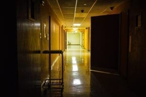 A dark hallway in a former hospital.