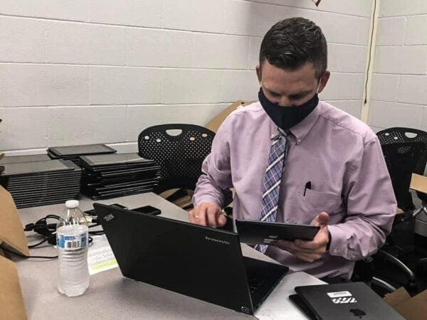 A man wearing a tie with a mask on.