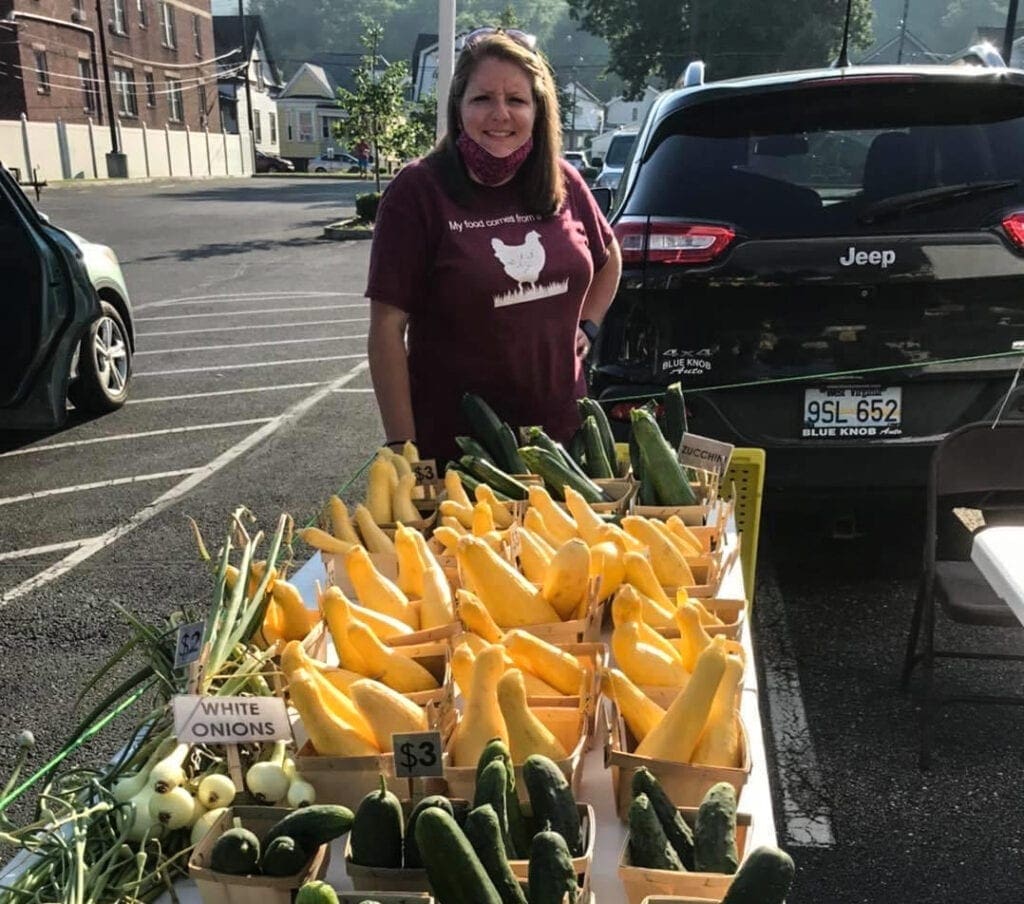 A woman selling produce at a market.