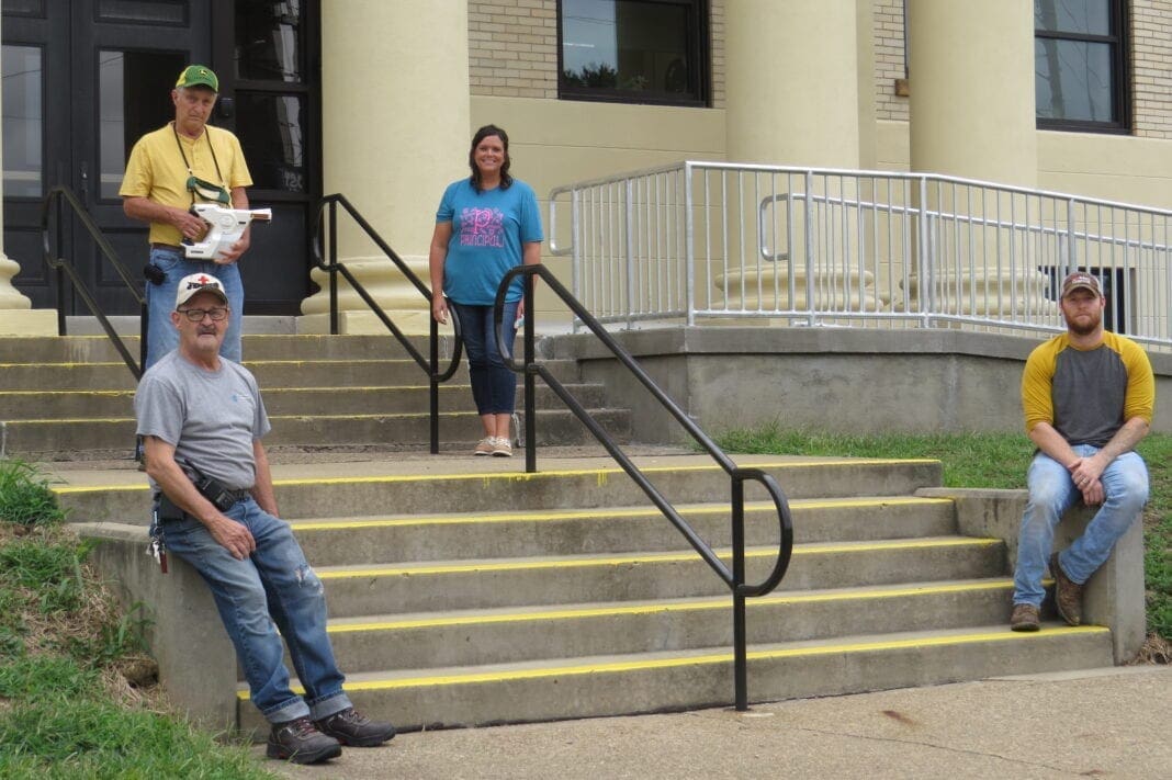 A group of people posing on steps.