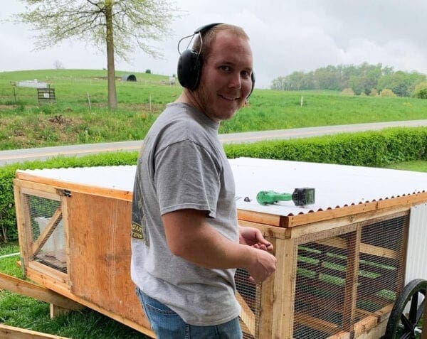 A photo of a farmer wearing headphones.