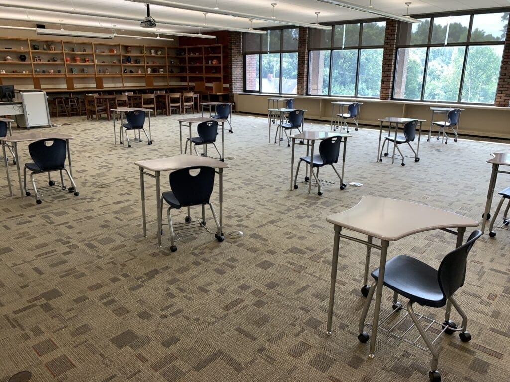 A large classroom with half the desks in it.