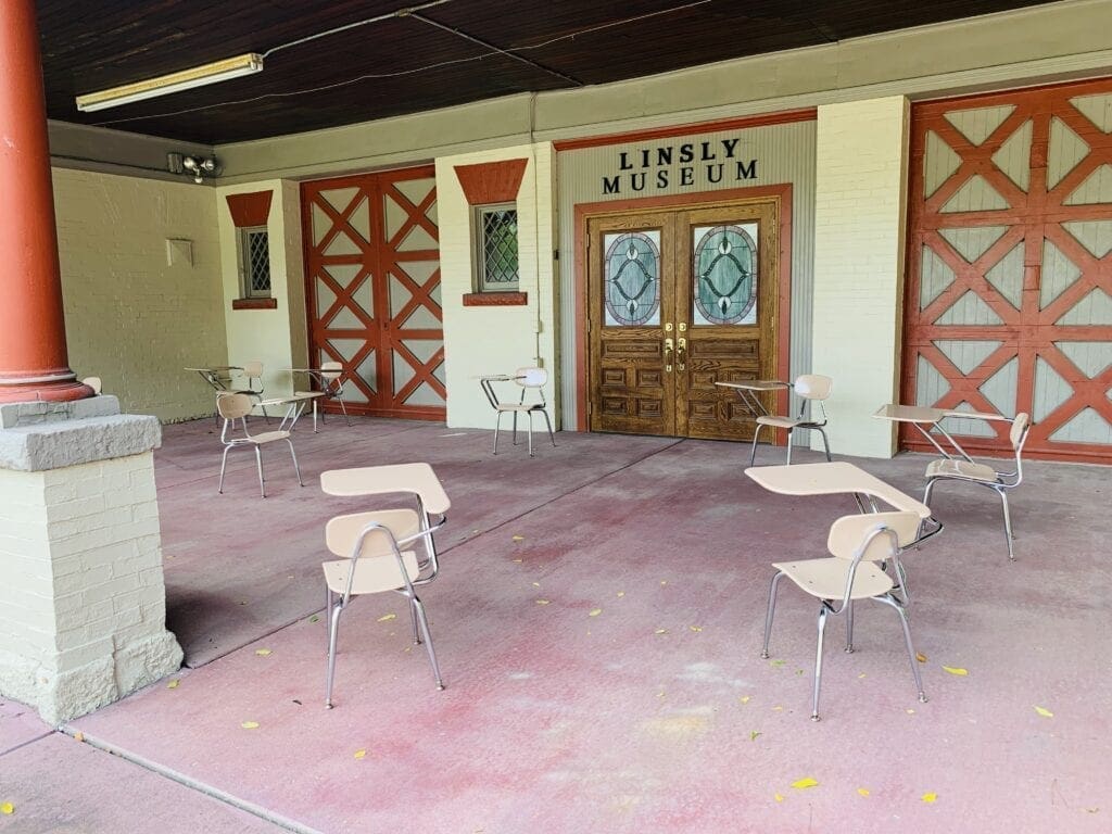 A number of student tables on a porch.