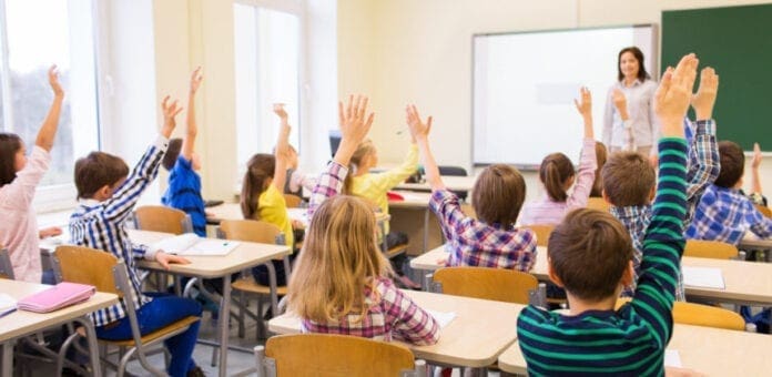 A teacher and students in a classroom.