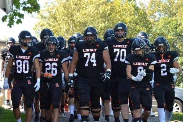 A football team in black jerseys.