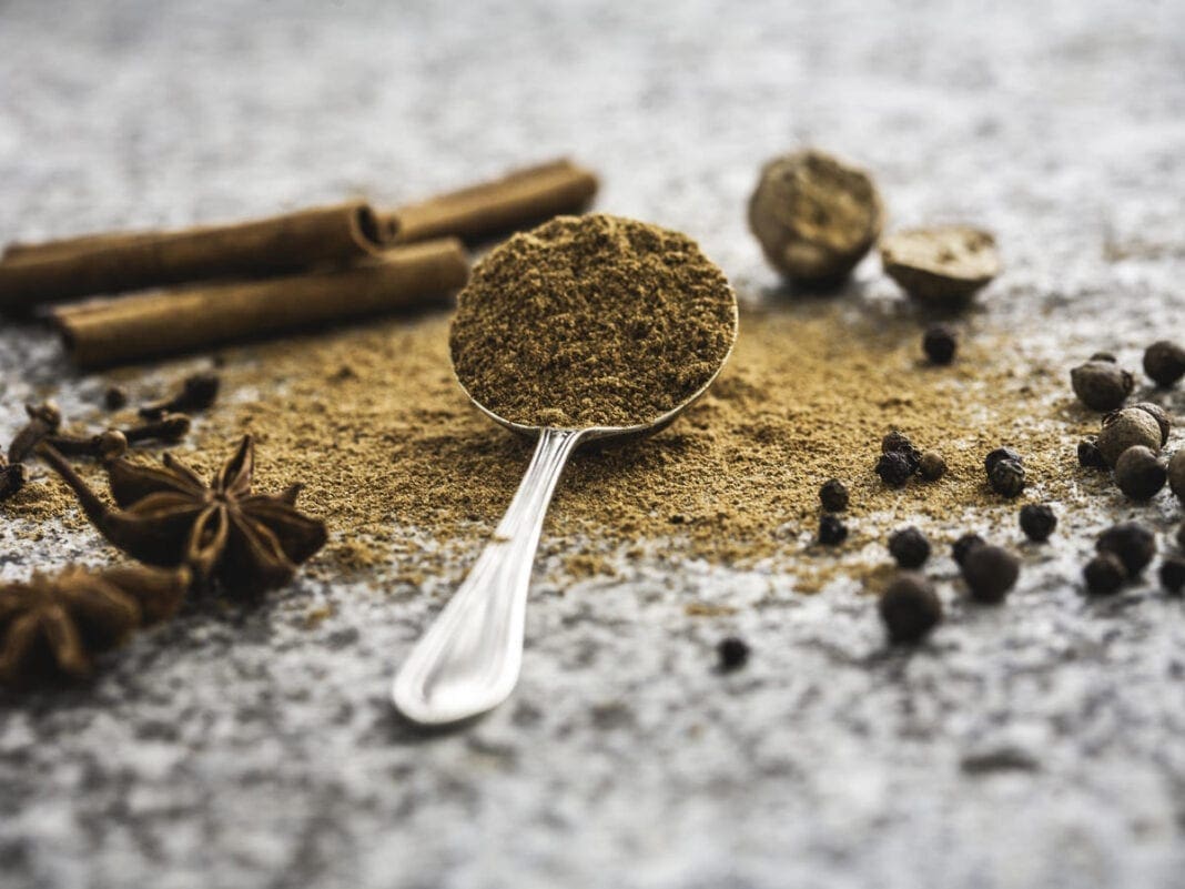 A photo of a spoon full of pumpkin spice.