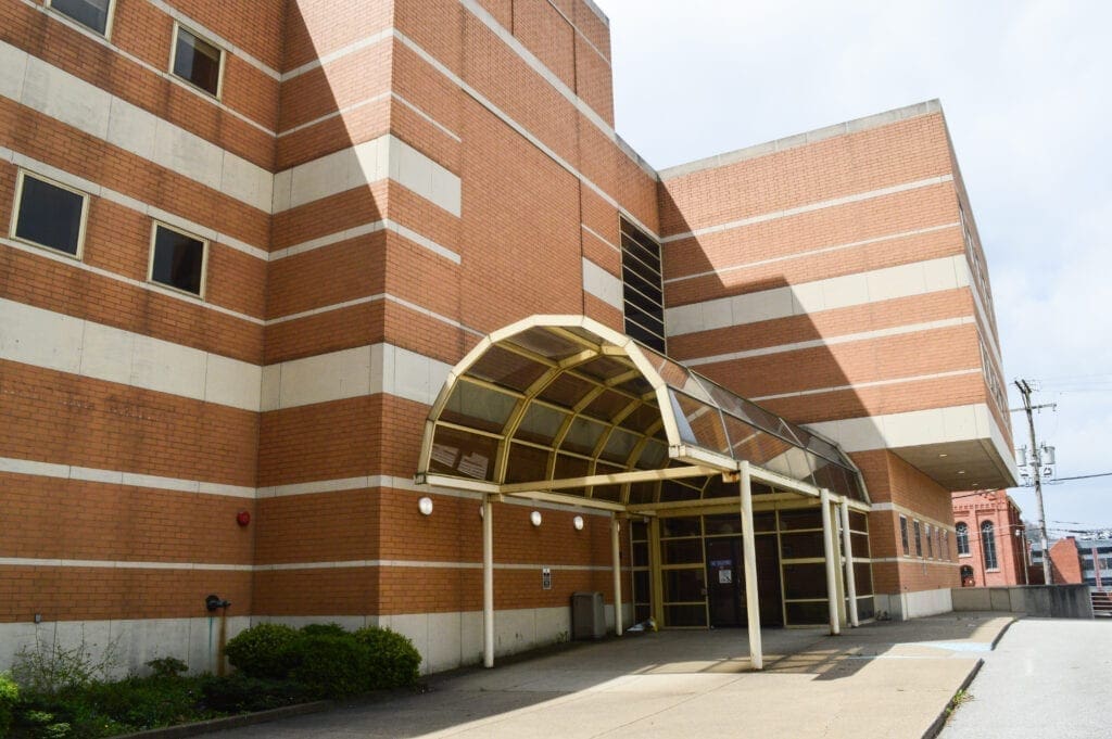 A three-story organge brick building.