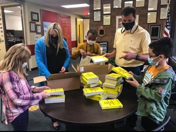 Students and teachers with books.