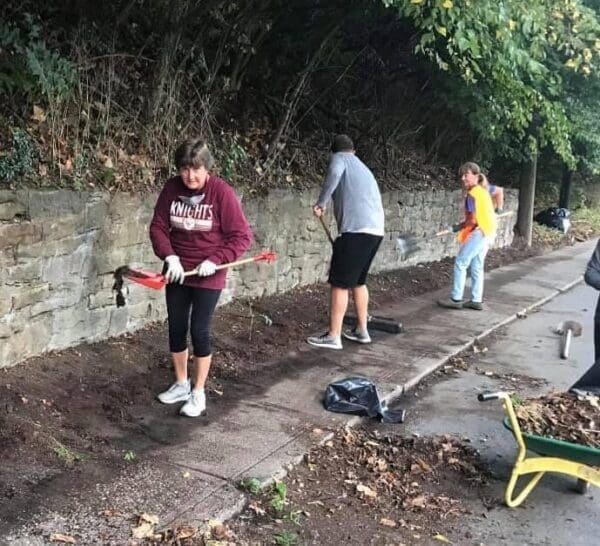 Three people with shovels.