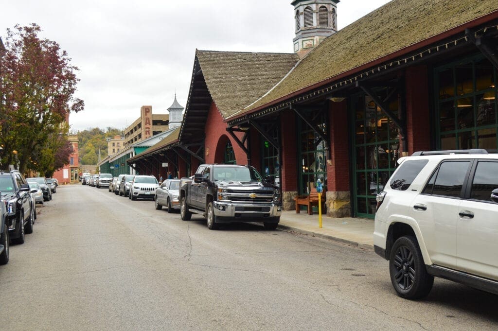 A lot of cars parking along a street.