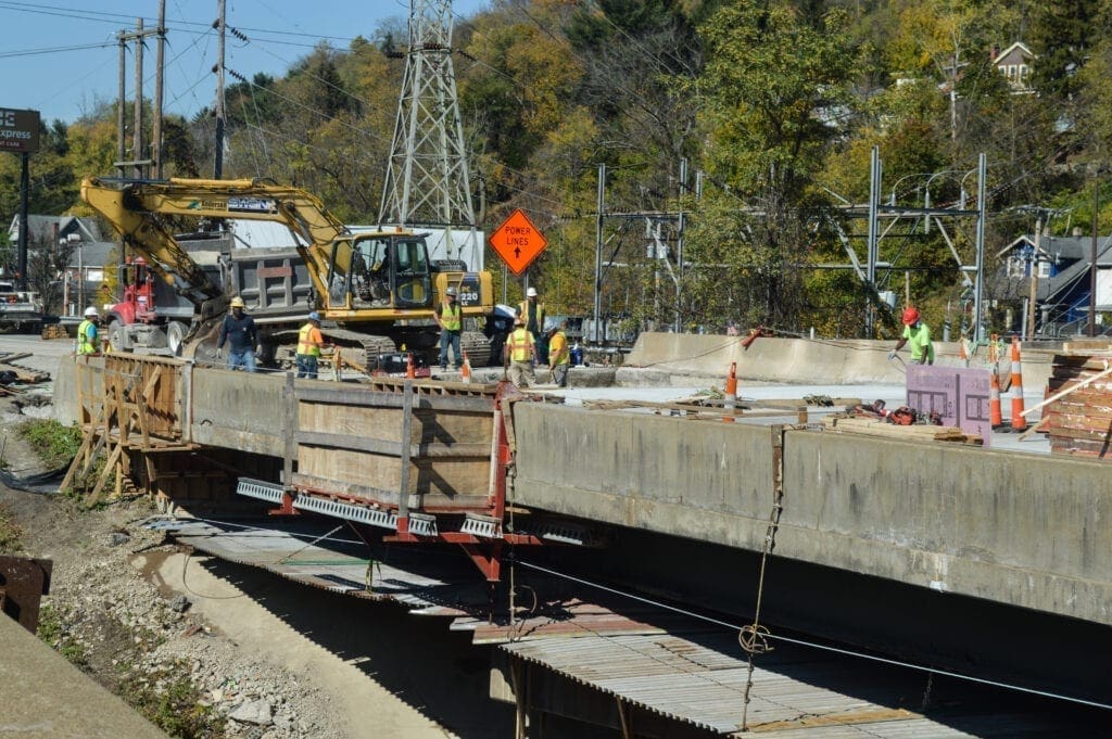 A construction crew on a bridge.