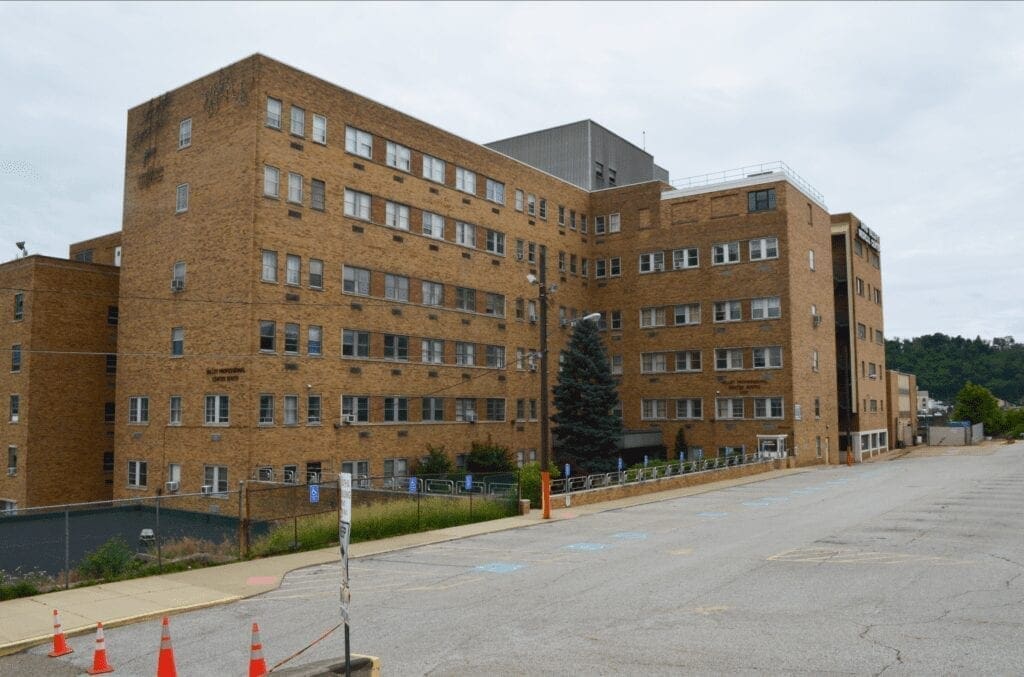 A building with a large parking lot.