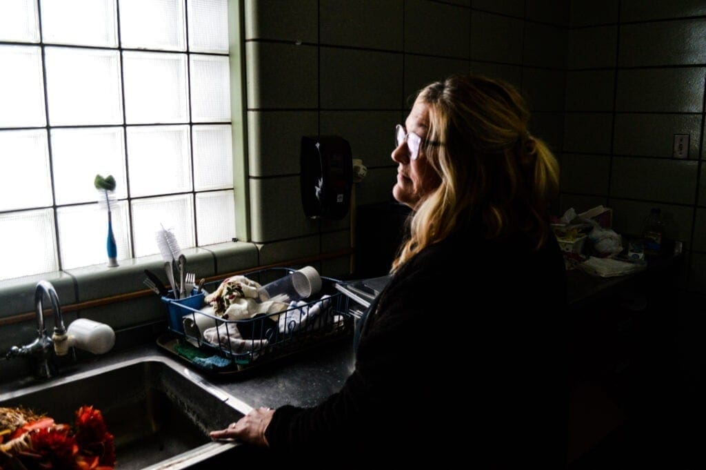 A woman in front of a window.