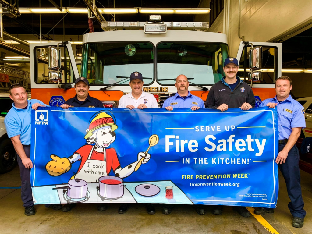 A group of firefighters holding a banner.