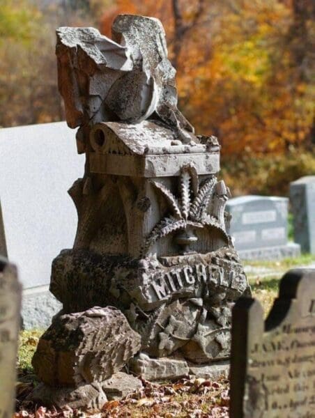 A grave stone in a cemetery.