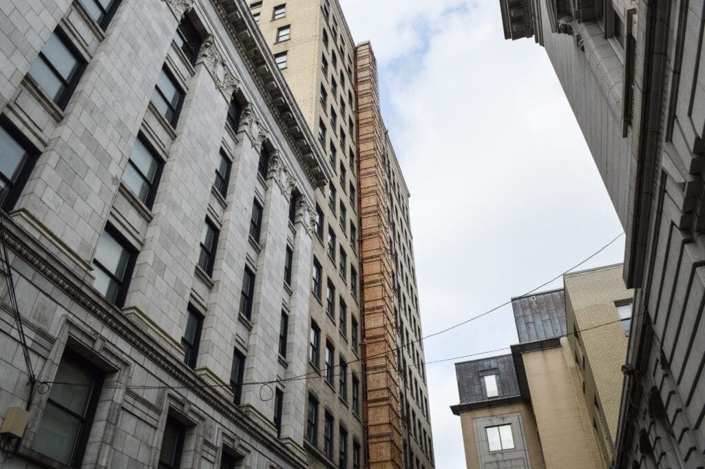 A wooden shaft on a tall building.