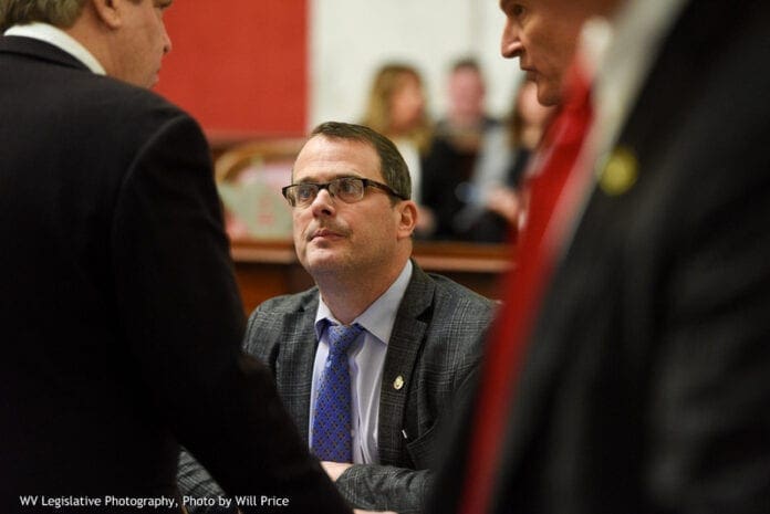 A men speaking with others.